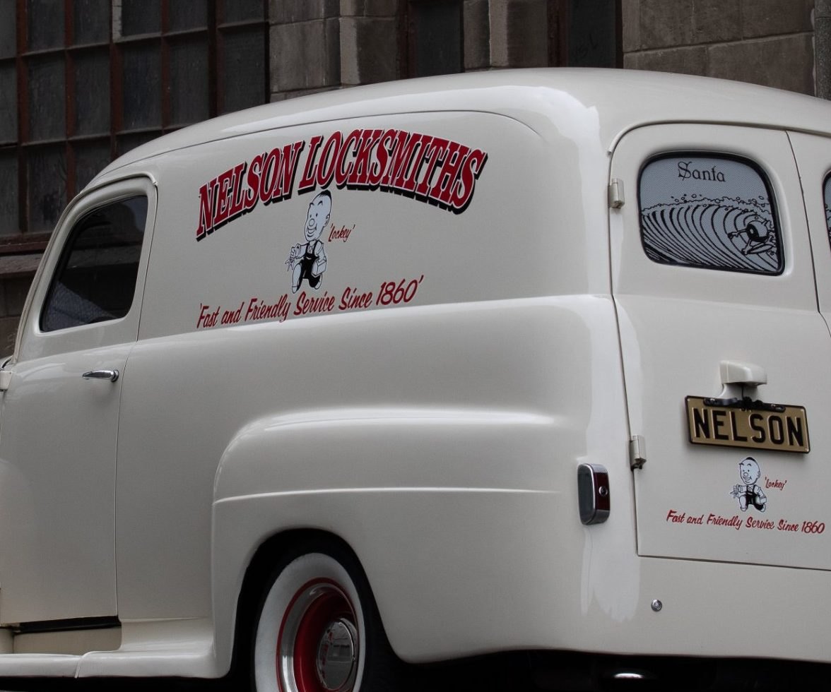 Signwriting on the Nelson panel van: the Nelson Locksmiths name, Lockey the running locksmith, and the old slogan “Fast and Friendly Service Since 1860”