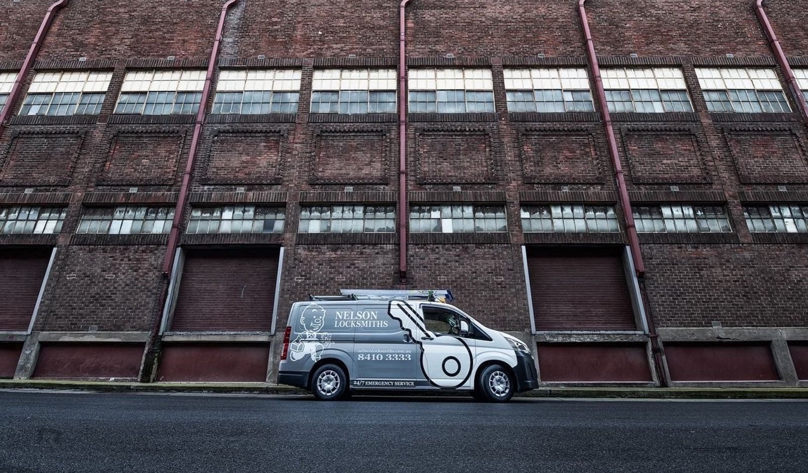 Nelson Locksmiths van outside a large brick warehouse