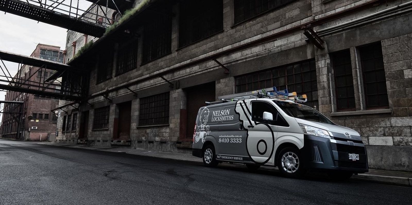 Nelson Locksmiths service van beside an old stone warehouse